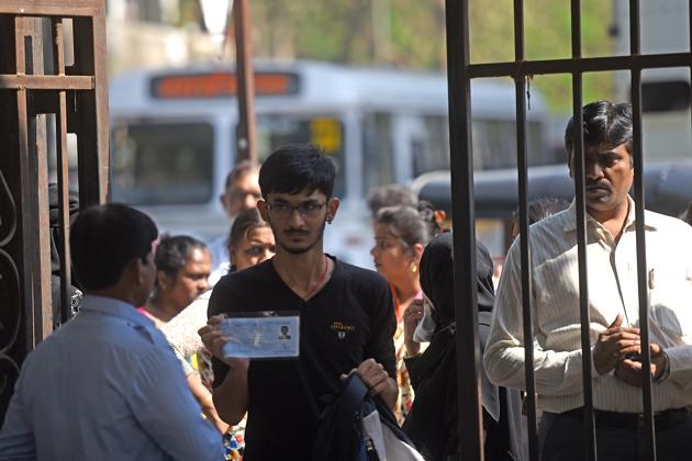 A student shows his hall ticket to enter a centre at Ghatkopar. Some centres in south Mumbai and the suburbs were unable to accommodate the large numbers of students, and were forced to move some of them to nearby schools. (Pratik Chorge/HT PHOTO) 