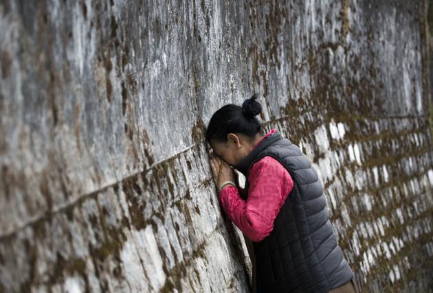 A Tibetan woman touches her head to the wall surrounding the residence of her spiritual leader the Dalai Lama on the third day of the Tibetan New Year called 'Losar' in Dharmsala. (Ashwini Bhatia / AP) A Tibetan woman touches her head to the wall surrounding the residence of her spiritual leader the Dalai Lama on the third day of the Tibetan New Year called 'Losar' in Dharmsala. (Ashwini Bhatia / AP)