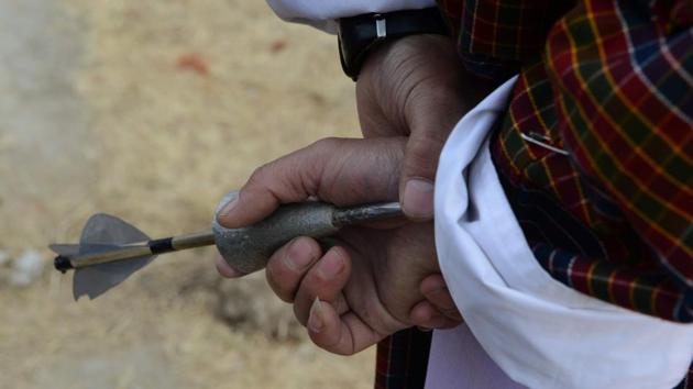A Bhutanese villager prepares to throw a dart as he takes part in a ‘Turung Game’ during the celebration of ‘Losar’ at Paro. (Diptendu DUTTA / AFP) A Bhutanese villager prepares to throw a dart as he takes part in a ‘Turung Game’ during the celebration of ‘Losar’ at Paro. (Diptendu DUTTA / AFP)