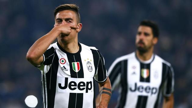 Juventus forward Paulo Dybala (L) celebrates after scoring against Napoli during the Italian Cup match.(AFP)