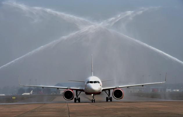 New Delhi: First Airbus 320 neo plane receiving a water cannon salute at Avionics Complex, Air India hanger IGI in New Delhi. Air India inducted the first Airbus 320 neo plane, touted as fuel efficient, into its fleet and plans to take 13 more such aircraft on lease this year.(PTI)