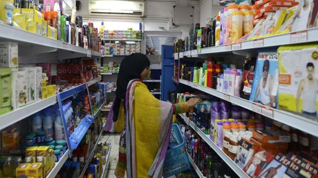 A customer selects products on the shelves in a supermarket in Ahmedabad.(AFP File)