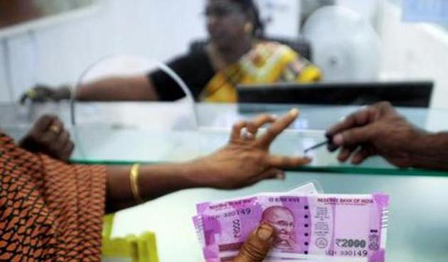 An Indian woman holds Rs 2000 notes as she has her finger marked with indelible ink after exchanging old notes of Rs 500 and Rs 1000 at a bank in Chennai, after the government demonetised these banknotes. (AFP) An Indian woman holds Rs 2000 notes as she has her finger marked with indelible ink after exchanging old notes of Rs 500 and Rs 1000 at a bank in Chennai, after the government demonetised these banknotes. (AFP)