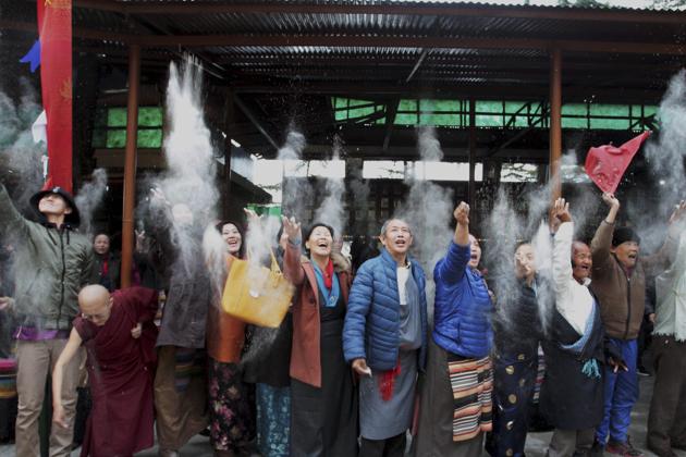 Tibetans in exile throwing barley flour in air on the 3rd day of Tibetan New Year ‘Losar’ at Mcleodganj in Dharamshala. (PTI) Tibetans in exile throwing barley flour in air on the 3rd day of Tibetan New Year ‘Losar’ at Mcleodganj in Dharamshala. (PTI)