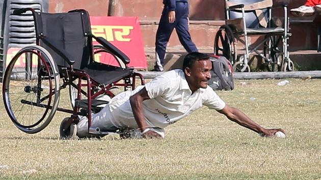A Punjab team player dives to save a boundary against Rajasthan during the final match played between Rajasthan and Punjab teams of Two Day National Triangular Wheelchair T-20 Cricket Series.