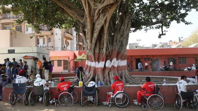 Players from the participating teams having lunch during a break.