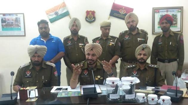 Police interacting with media during a press conference in Sangrur on Thursday.(HT Photo)