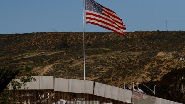 A U.S. flag is seen next to a section of the wall separating Mexico and the United States of America.(Reuters File Photo)