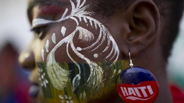A performer waits during a pause on the Carnival parade route in Les Cayes, Haiti. Haiti's three-day Carnival festivities have brought rum-fueled parties, imaginative costumes and high-energy dance music to a southern city that's still recovering from last year's punishing Hurricane Matthew. (Dieu Nalio Chery/AP) A performer waits during a pause on the Carnival parade route in Les Cayes, Haiti. Haiti's three-day Carnival festivities have brought rum-fueled parties, imaginative costumes and high-energy dance music to a southern city that's still recovering from last year's punishing Hurricane Matthew. (Dieu Nalio Chery/AP)