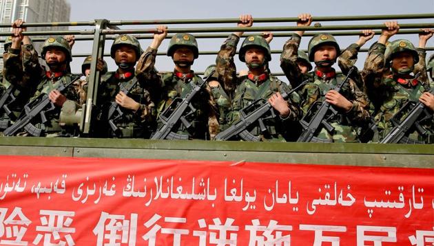 This photo taken on February 27 shows Chinese military police attending an anti-terrorist oath-taking rally in Hetian, northwest China's Xinjiang Uighur Autonomous Region. (AFP photo) This photo taken on February 27 shows Chinese military police attending an anti-terrorist oath-taking rally in Hetian, northwest China's Xinjiang Uighur Autonomous Region. (AFP photo)