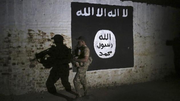 An Iraqi soldier inspects an area adorned with an Islamic State flag in Mosul on March 1. (AP) An Iraqi soldier inspects an area adorned with an Islamic State flag in Mosul on March 1. (AP)