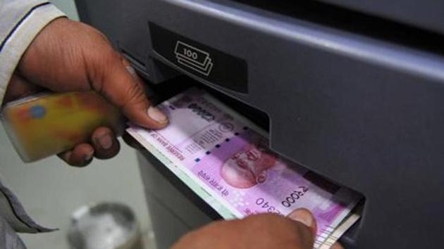 Indore, India - Nov. 18, 2016: A man takes out Rs 2000 currency note from an ATM in Indore, India, on Friday, November 18, 2016. (Photo by Shankar Mourya/ HT/ PHOTO) With Manoj Ahuja story (Shankar Mourya/HT Photo) Indore, India - Nov. 18, 2016: A man takes out Rs 2000 currency note from an ATM in Indore, India, on Friday, November 18, 2016. (Photo by Shankar Mourya/ HT/ PHOTO) With Manoj Ahuja story (Shankar Mourya/HT Photo)