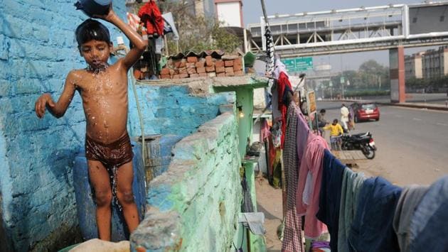 A child bathes upon return from school at Sector 16 slum colony, in Noida. Living in a slum life often means going without basic sanitation facilities. It remains to be seen whether the initiative will help slum dwellers find a better quality of life. (Burhaan Kinu/HT PHOTO) A child bathes upon return from school at Sector 16 slum colony, in Noida. Living in a slum life often means going without basic sanitation facilities. It remains to be seen whether the initiative will help slum dwellers find a better quality of life. (Burhaan Kinu/HT PHOTO)