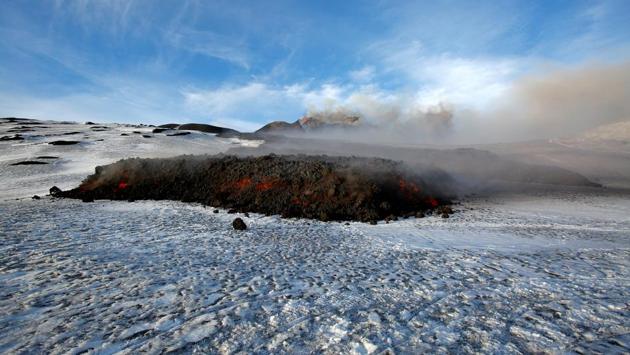 Pouring lava is seen flowing on the snow covered Mount Etna . (Antonio Parrinello / REUTERS)