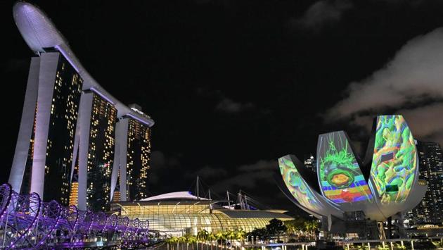 A light-art installation projected on Art Science Museum dome (R) by Syndicate of Singapore titled ‘Secret Galaxies’ . (ROSLAN RAHMAN / AFP)