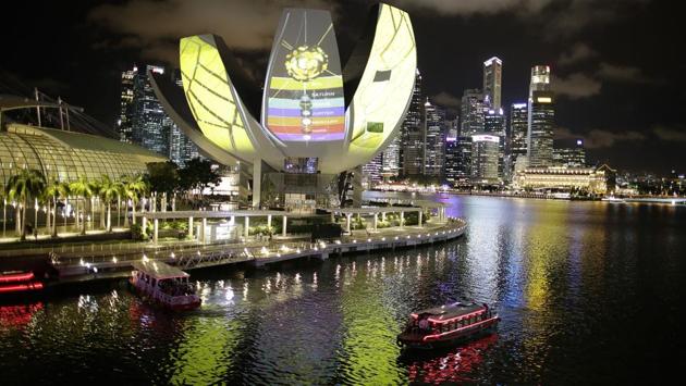 A projection of a digital art piece titled ‘Secret Garden’ glows from the surface of the Art Science Museum at the Marina Bay Sands . (Wong Maye-E / AP)