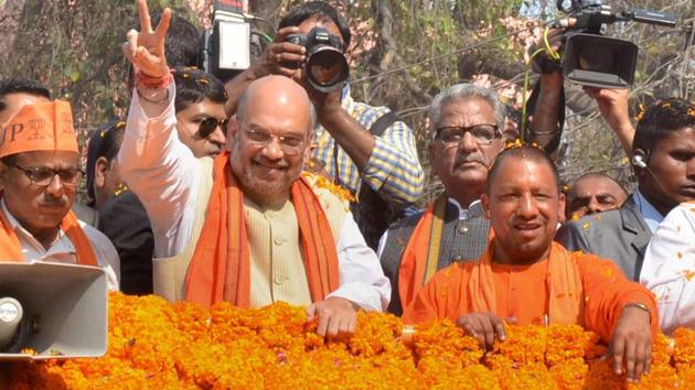 BJP president Amit Shah with party MP Yogi Aditya Nath during an election road show in Gorakhpur district on Thursday. (PTI) BJP president Amit Shah with party MP Yogi Aditya Nath during an election road show in Gorakhpur district on Thursday. (PTI)