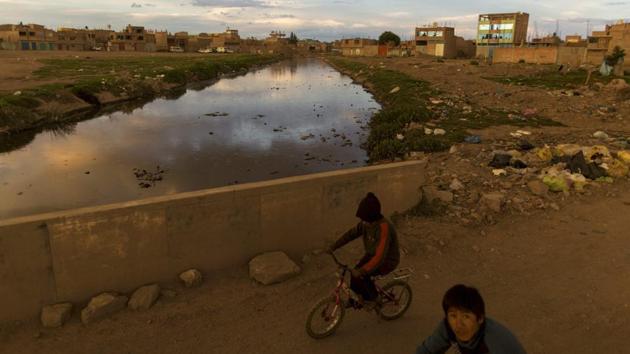Children ride bikes along the Torococha River near a municipal waste treatment plant with water that flows into Lake Titicaca, in Juliaca. Many of the more than 400,000 tourists who visit Lake Titicaca from Peru each year stop first in Juliaca, a town that produces 200 tons of trash daily, much of it winding up in a river that has turned into a conveyor belt of waste heading into the lake. (AP) Children ride bikes along the Torococha River near a municipal waste treatment plant with water that flows into Lake Titicaca, in Juliaca. Many of the more than 400,000 tourists who visit Lake Titicaca from Peru each year stop first in Juliaca, a town that produces 200 tons of trash daily, much of it winding up in a river that has turned into a conveyor belt of waste heading into the lake. (AP)
