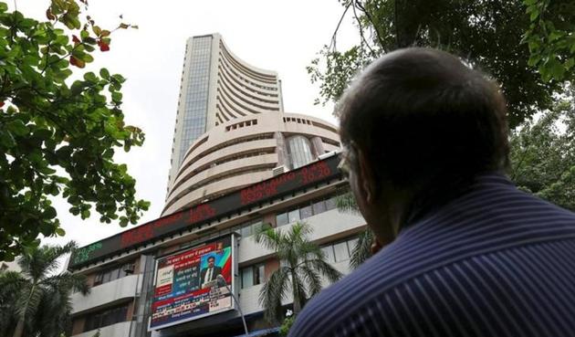 A man looks at a screen across a road displaying the Sensex on the facade of the Bombay Stock Exchange (BSE) building in Mumbai, India. (Reuters File Photo) A man looks at a screen across a road displaying the Sensex on the facade of the Bombay Stock Exchange (BSE) building in Mumbai, India. (Reuters File Photo)