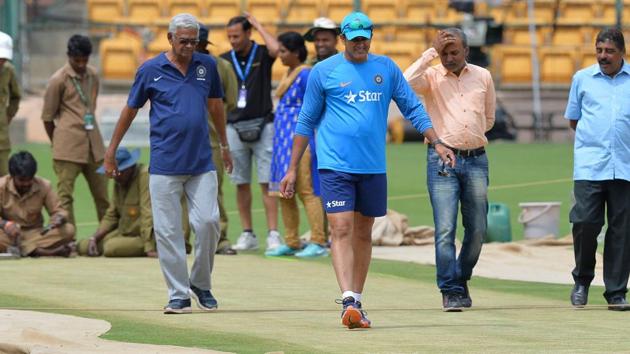 India cricket team coach, Anil Kumble (centre) takes a close look at the Chinnaswamy Stadium pitch during training on Thursday. The second Test against Australia cricket team begins in Bangalore on Saturday. With the Pune pitch (first Test) termed as ‘poor’ by the ICC match referee, there will be a lot of attention on how the Bangalore Test pitch plays, the hope being that the match lasts five days. (AFP) India cricket team coach, Anil Kumble (centre) takes a close look at the Chinnaswamy Stadium pitch during training on Thursday. The second Test against Australia cricket team begins in Bangalore on Saturday. With the Pune pitch (first Test) termed as ‘poor’ by the ICC match referee, there will be a lot of attention on how the Bangalore Test pitch plays, the hope being that the match lasts five days. (AFP)