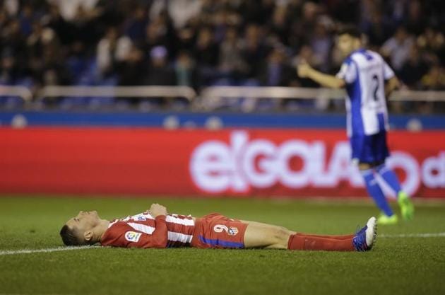 Fernando Torres of Atletico Madrid lies on the field after colliding during a Spanish league football match vs Deportivo de la Coruna at the Municipal de Riazor stadium in La Coruna on Thursday.(Reuters)