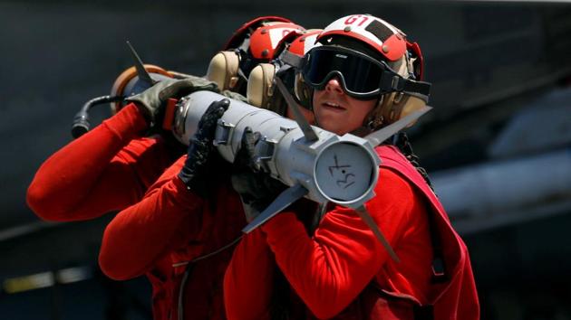 US Navy personnel carry a missile on aircraft carrier USS Carl Vinson during a FONOPS (Freedom of Navigation Operation Patrol) in South China Sea. (Erik De / REUTERS) US Navy personnel carry a missile on aircraft carrier USS Carl Vinson during a FONOPS (Freedom of Navigation Operation Patrol) in South China Sea. (Erik De / REUTERS)