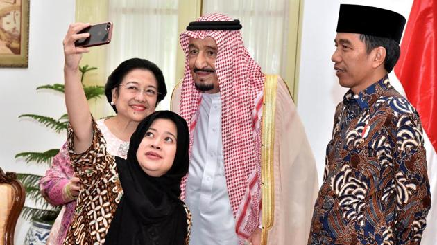 Indonesian President Joko Widodo (right) watches as former president Megawati Sukarnoputri and her daughter Puan Maharani, a minister in his cabinet, take a selfie with Saudi Arabia's King Salman (centre) at the presidential palace in Jakarta, Indonesia. (Agus Suparto / REUTERS) Indonesian President Joko Widodo (right) watches as former president Megawati Sukarnoputri and her daughter Puan Maharani, a minister in his cabinet, take a selfie with Saudi Arabia's King Salman (centre) at the presidential palace in Jakarta, Indonesia. (Agus Suparto / REUTERS)