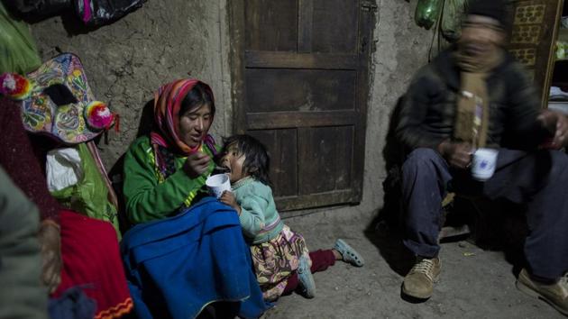 Maria Avila feeds her daughter Shomara in their family's adobe home in Coata, a village on the shored of Lake Titicaca. Avila grew angry as she talked about the lake’s contamination. My ancestors have lived here more than 500 years. They have never gone through these things, she said. (Rodrigo Abd/AP) Maria Avila feeds her daughter Shomara in their family's adobe home in Coata, a village on the shored of Lake Titicaca. Avila grew angry as she talked about the lake’s contamination. My ancestors have lived here more than 500 years. They have never gone through these things, she said. (Rodrigo Abd/AP)