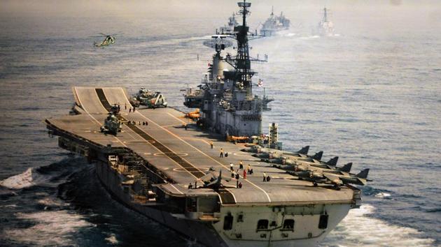An old undated photograph of INS Viraat at sea with its deck lined up with jets and choppers. The iconic Indian aircraft carrier will be decommissioned officially today at a ceremony in Mumbai. We look back at some images of the ship in action over the last few decades. (PIB)