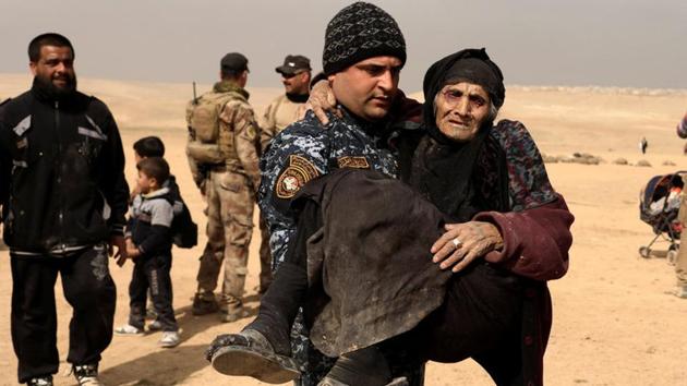 Carried across the desert by her grandsons, under sniper and mortar fire, she was one of thousands who braved the difficult and dangerous journey out of Islamic State’s shrinking stronghold in the west of the city. (Zohra Bensemra/REUTERS)