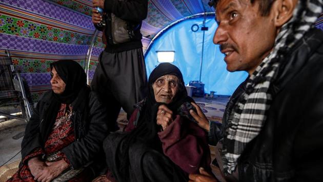 Khatla Ali Abdullah, 90, who recently fled her home in Al Mamoun district talks to her relative as she sits with her daughter (L) in her tent in Hammam al Alil camp. I haven’t lost any chickens, not even a one little chick,” she said. We were trapped in the basement and we could hear the bullets hitting the metal roof of the chicken pen. (Zohra Bensemra/REUTERS)