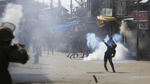 A Kashmiri youth throws stones during clashes with police and paramilitary soldiers in downtown area of Srinagar, on March 3, 2017. Police fired dozens of tear smoke shells and fired pellets in the air to disperse the crowds.(Waseem Andrabi / HT Photo) A Kashmiri youth throws stones during clashes with police and paramilitary soldiers in downtown area of Srinagar, on March 3, 2017. Police fired dozens of tear smoke shells and fired pellets in the air to disperse the crowds.(Waseem Andrabi / HT Photo)