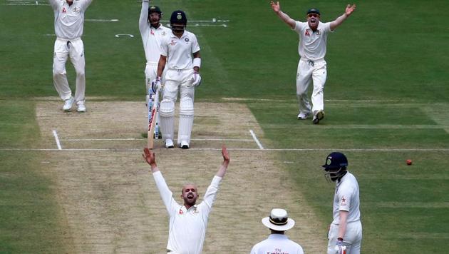 Australian players successfully appeal for the wicket of India's captain Virat Kohli in Bangalore on Saturday. Nathan Lyon got the all-important wicket of Kohli, who fell for 12. India were all out for 189.(REUTERS)