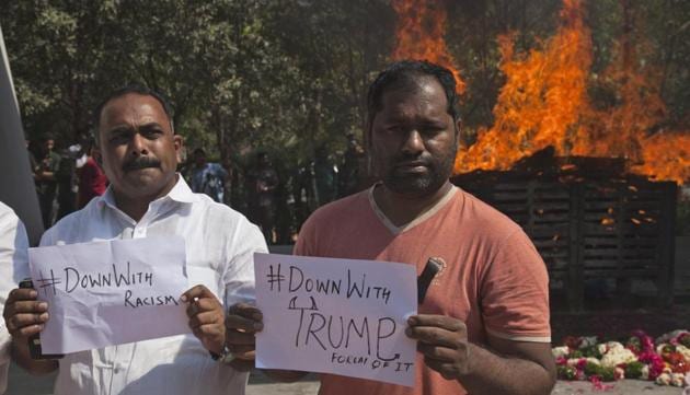 Indians hold placards in front of the cremation pyre of Srinivas Kuchibhotla, a 32-year-old engineer who was killed in a racially motivated shooting in a crowded Kansas bar, at a crematorium in Hyderabad on February 28.(AP)