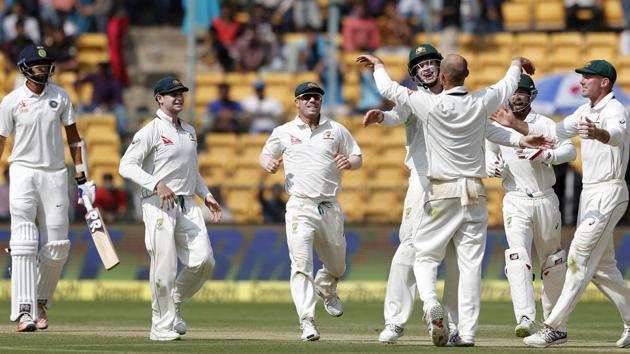 Australia's Nathan Lyon (back to camera), celebrates with teammates the wicket India's Ishant Sharma (left), his eighth victim of the innings during Day 1 of the second Test at Chinnaswamy Stadium in Bangalore on Saturday. He returned with figures of 8/50, the best by an Australian bowler against India. (AP) Australia's Nathan Lyon (back to camera), celebrates with teammates the wicket India's Ishant Sharma (left), his eighth victim of the innings during Day 1 of the second Test at Chinnaswamy Stadium in Bangalore on Saturday. He returned with figures of 8/50, the best by an Australian bowler against India. (AP)