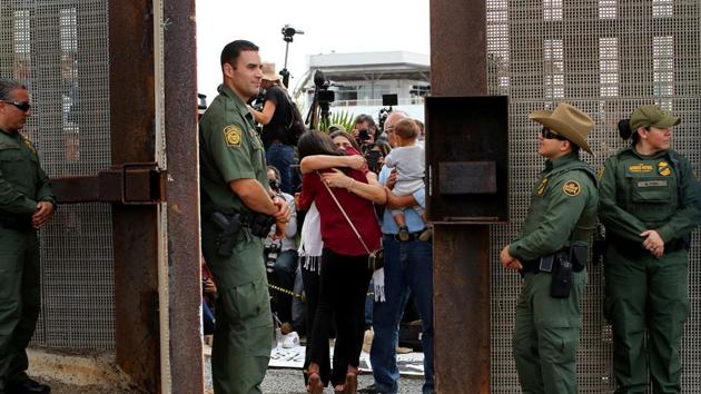 US Border patrol agents stand watch at an open gate on the fence along the Mexico border to allow Delia Valdovinos-Sanchez to embrace Ramona Vargas, as part of Universal Children's Day at the Border Field State Park, California, U.S. on November 19, 2016. (Reuters File) US Border patrol agents stand watch at an open gate on the fence along the Mexico border to allow Delia Valdovinos-Sanchez to embrace Ramona Vargas, as part of Universal Children's Day at the Border Field State Park, California, U.S. on November 19, 2016. (Reuters File)