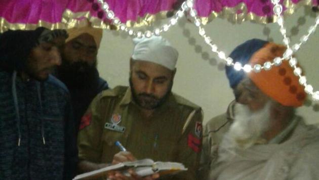 A cop probing the sacrilege at a gurdwara in the Devi Nagar locality of Dera Bassi near Chandigarh on Sunday. (HT Photo) A cop probing the sacrilege at a gurdwara in the Devi Nagar locality of Dera Bassi near Chandigarh on Sunday. (HT Photo)
