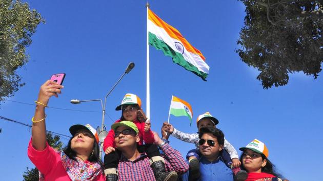 Tourists take photos with India’s highest tricolour hoisted at Attari Border near Amritsar on Sunday, March 05, 2017.(Sameer Sehgal/ Hindustan Times)