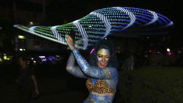 A woman spins a flashing hula hoop as she prepares for the annual Gay and Lesbian Mardi Gras parade in Sydney. (Rick Rycroft/AP) A woman spins a flashing hula hoop as she prepares for the annual Gay and Lesbian Mardi Gras parade in Sydney. (Rick Rycroft/AP)