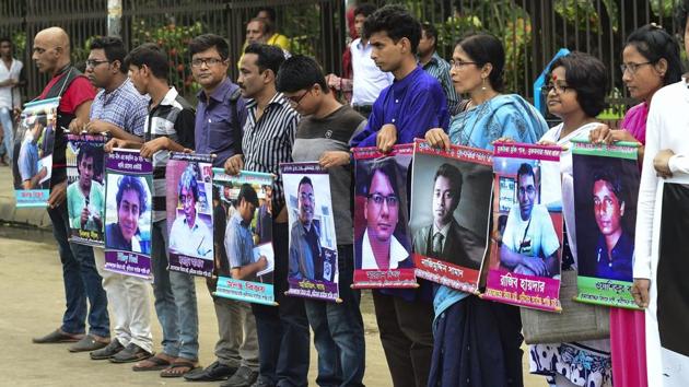 Bangladeshi activists hold the photos of activists, writers and bloggers who were murdered by unidentified people in the last few years, in Dhaka, in June 2016. (AFP File Photo) Bangladeshi activists hold the photos of activists, writers and bloggers who were murdered by unidentified people in the last few years, in Dhaka, in June 2016. (AFP File Photo)