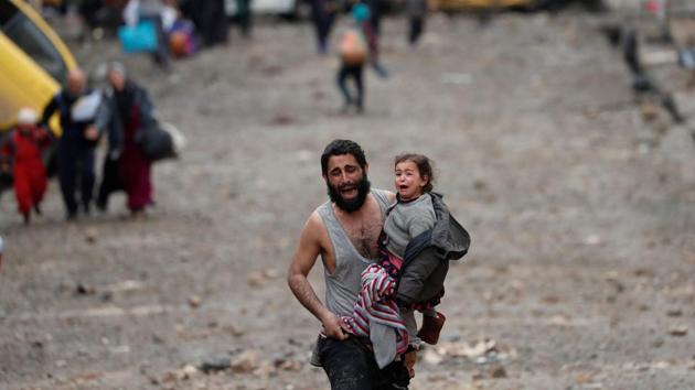 A man cries while carrying his daughter as he walks from Islamic State controlled part of Mosul towards Iraqi special forces soldiers during a battle in Mosul, Iraq. (Goran Tomasevic/REUTERS) A man cries while carrying his daughter as he walks from Islamic State controlled part of Mosul towards Iraqi special forces soldiers during a battle in Mosul, Iraq. (Goran Tomasevic/REUTERS)