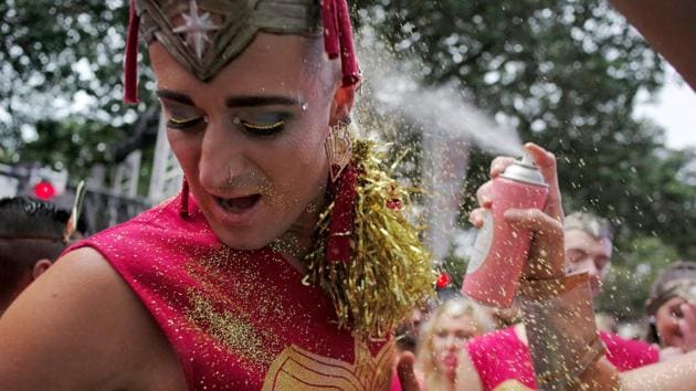 A participant tries to escape the glitter sprayed during the parade. Despite having a vibrant gay population, same-sex marriage is still illegal in Australia with the country seen as lagging behind other nations. (Jason reed/REUTERS) A participant tries to escape the glitter sprayed during the parade. Despite having a vibrant gay population, same-sex marriage is still illegal in Australia with the country seen as lagging behind other nations. (Jason reed/REUTERS)