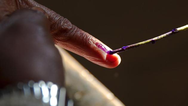 A polling officer marks the finger of a woman with ink before she casts her vote at Muradnagar, in Uttar Pradesh. A model code of conduct is enforced as soon as elections are announced (AP) A polling officer marks the finger of a woman with ink before she casts her vote at Muradnagar, in Uttar Pradesh. A model code of conduct is enforced as soon as elections are announced (AP)