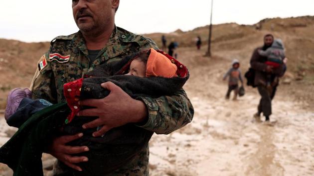 "Hashid Shaabi" member, also know as Popular Mobilisation carries a displaced Iraqi child while Iraqi forces battle with Islamic State militants, in western Mosul. (Zohra Bensemra/REUTERS) "Hashid Shaabi" member, also know as Popular Mobilisation carries a displaced Iraqi child while Iraqi forces battle with Islamic State militants, in western Mosul. (Zohra Bensemra/REUTERS)