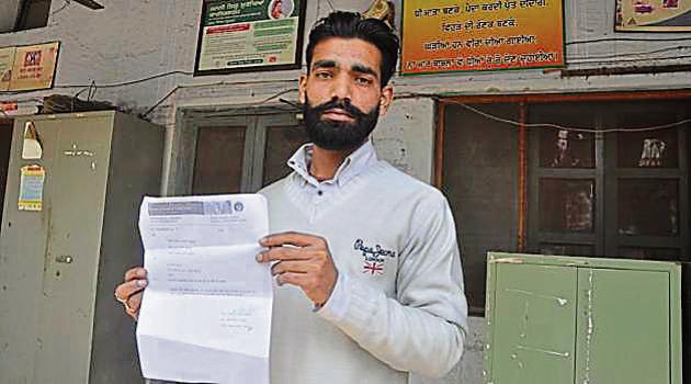 Sanjeev Kumar showing a copy of the complaint regarding the death of his child at the civil surgeon office in Jalandhar.(Sikander Singh Chopra/HT)