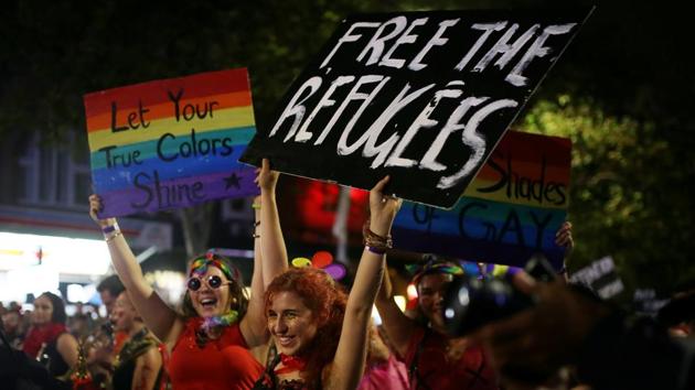 Marchers with political statements on refugees detained by Australian government hold signs during the parade. (Steven Saphore/REUTERS) Marchers with political statements on refugees detained by Australian government hold signs during the parade. (Steven Saphore/REUTERS)