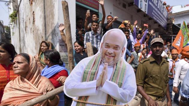 Supporters carry a cut-out of Amit Shah at prime Minister Narendra Modi's road show in Varanasi on March 4, 2017. (Arun Sharma/HT PHOTO) Supporters carry a cut-out of Amit Shah at prime Minister Narendra Modi's road show in Varanasi on March 4, 2017. (Arun Sharma/HT PHOTO)