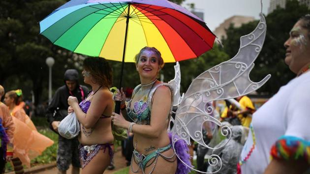 A participant holds a rainbow umbrella as it rains during the annual Sydney Gay and Lesbian Mardi Gras parade. (Steven Saphore/REUTERS) A participant holds a rainbow umbrella as it rains during the annual Sydney Gay and Lesbian Mardi Gras parade. (Steven Saphore/REUTERS)