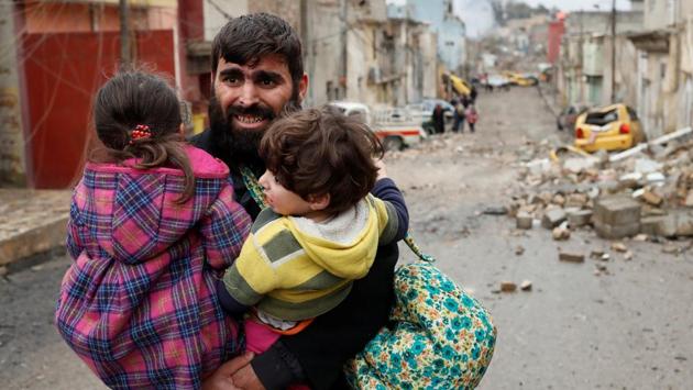 A man carries his children as he walks from Islamic State controlled part of Mosul towards Iraqi special forces soldiers during a battle. Unfortunately, there is a clear shortfall in the work of these (UN) organisations, said Jassem Mohammed al-Jaff, the minister of displacement and migration. (Goran Tomasevic/REUTERS) A man carries his children as he walks from Islamic State controlled part of Mosul towards Iraqi special forces soldiers during a battle. Unfortunately, there is a clear shortfall in the work of these (UN) organisations, said Jassem Mohammed al-Jaff, the minister of displacement and migration. (Goran Tomasevic/REUTERS)