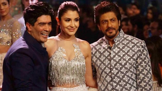 The two pose for the camera with designer Manish Malhotra. (HT Photo/Prodip Guha) 